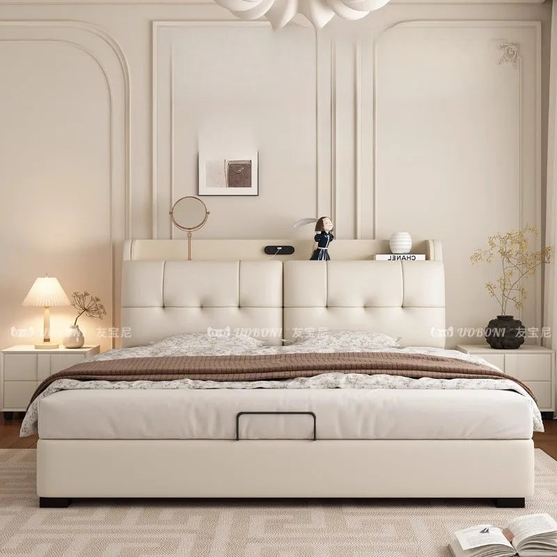Modern cream leather bed frame featuring a tufted, integrated headboard with storage shelf and a practical base drawer.