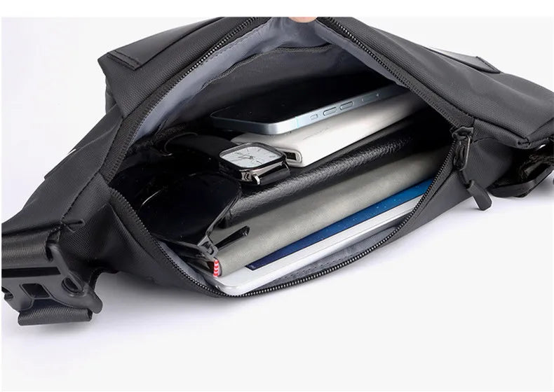 Inside view of a black anti-theft crossbody sling bag, filled with a phone, wallet, watch, and sunglasses.