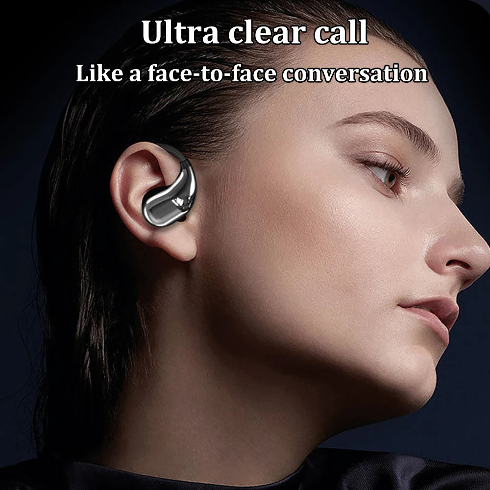 A person wearing a sleek, metallic silver, open-ear style wireless earbud against a dark background.