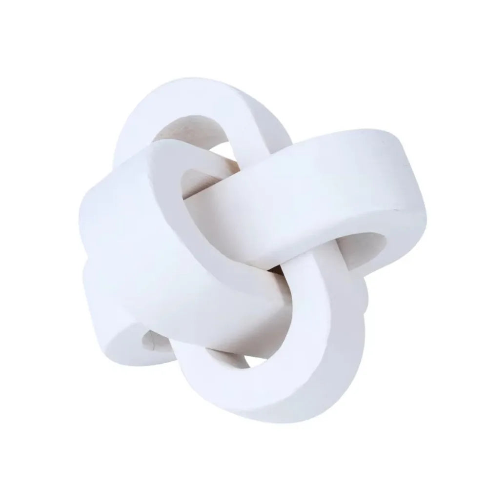 Decorative white wooden knot ornament with an interlocking geometric design for contemporary home styling.