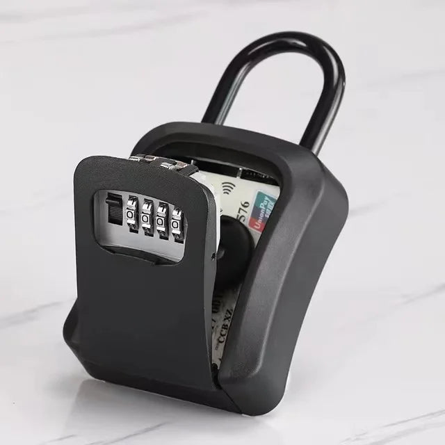 Black metal padlock-style key storage box with a 4-digit combination lock and an open lid revealing a credit card.