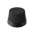 Compact, matte black, cone-shaped wireless speaker with a mesh fabric top and a charging port at the base.