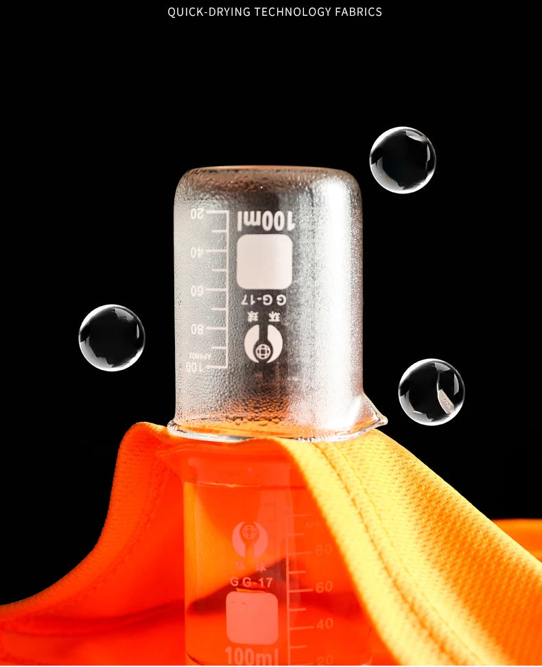 Bright orange high-visibility work polo shirt fabric being tested for quick-drying properties with water droplets.