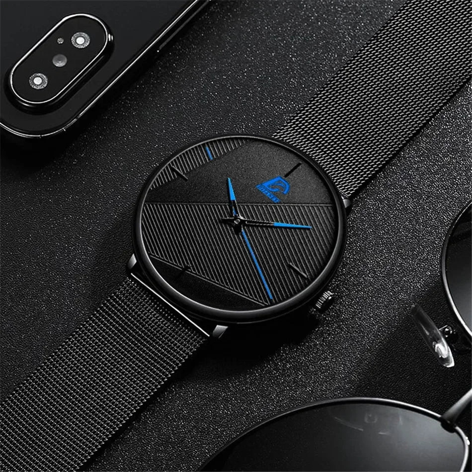 Minimalist men’s watch with an ultra-thin black mesh strap, textured black dial and striking blue hands.