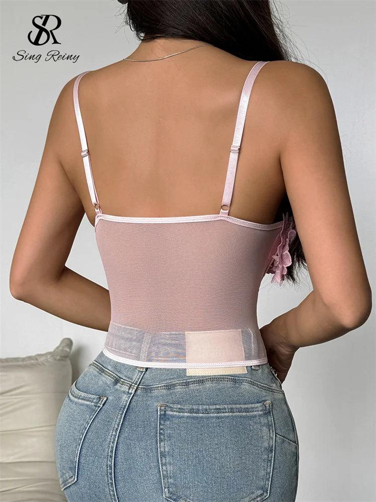 Pink sheer gauze slim camisole with thin adjustable straps, worn with jeans, viewed from the back.
