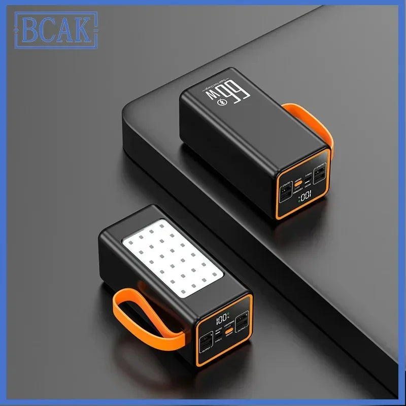 Two black portable power banks with orange carry straps, LED digital displays, and built-in panel lights.