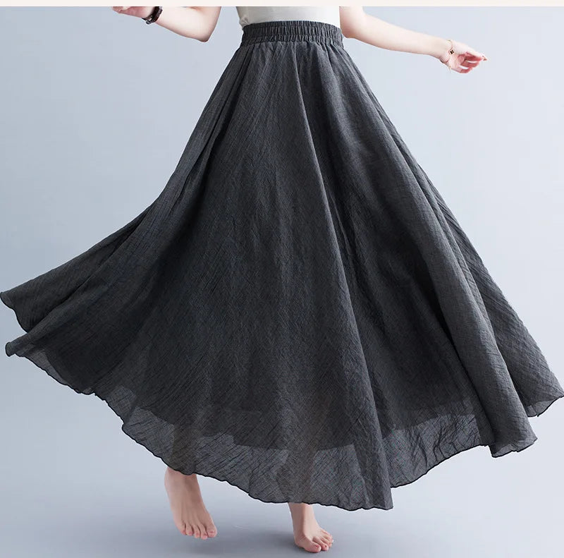 Dark grey, high-waisted, flowy maxi skirt with a textured fabric finish and a comfortable elasticated waistband.
