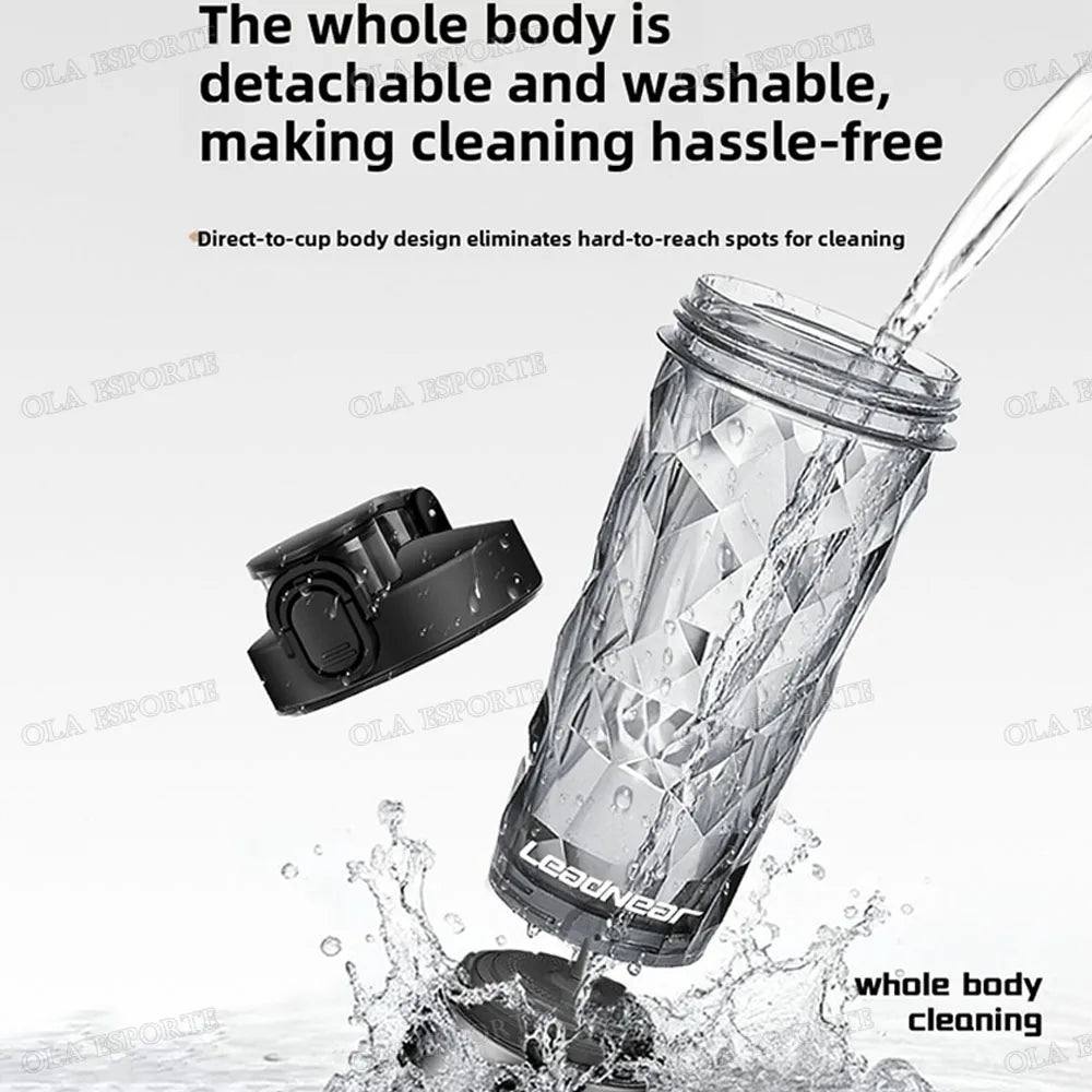 Clear, geometric-patterned shaker bottle with a detachable black lid, displayed with water pouring into it.