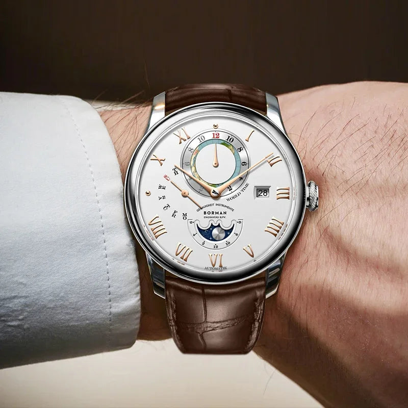 Men’s mechanical wristwatch with a white dial, rose-gold Roman numerals, moon phase display, and brown leather strap.