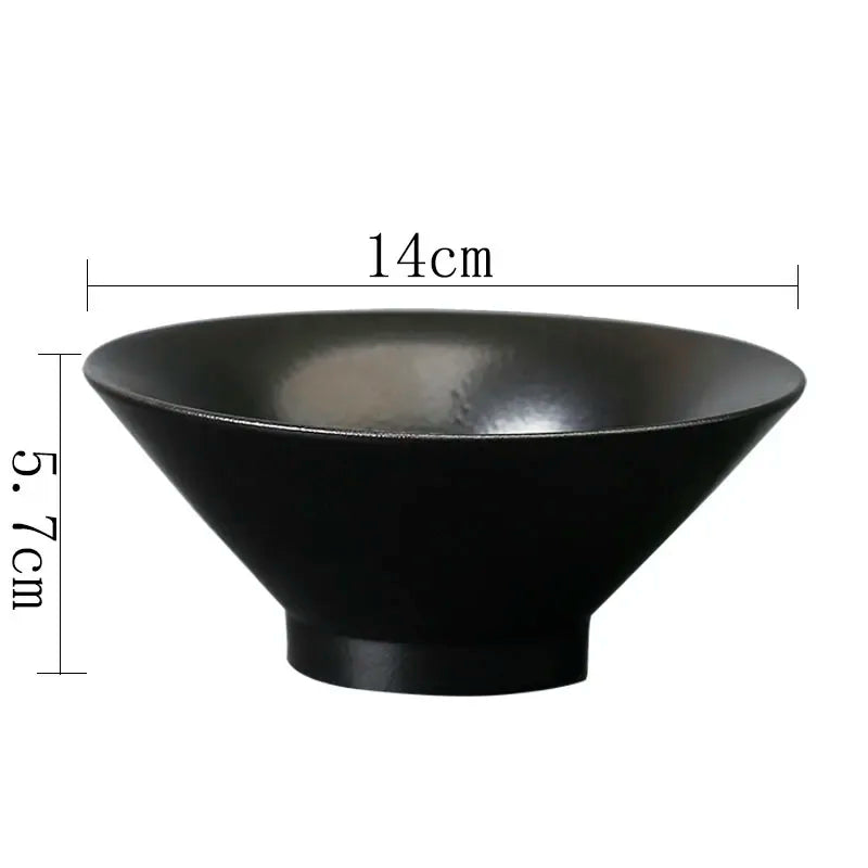 Matte black ceramic bowl with a wide, flared rim. Measures 14cm in diameter and 5.7cm in height. Modern, minimalist.