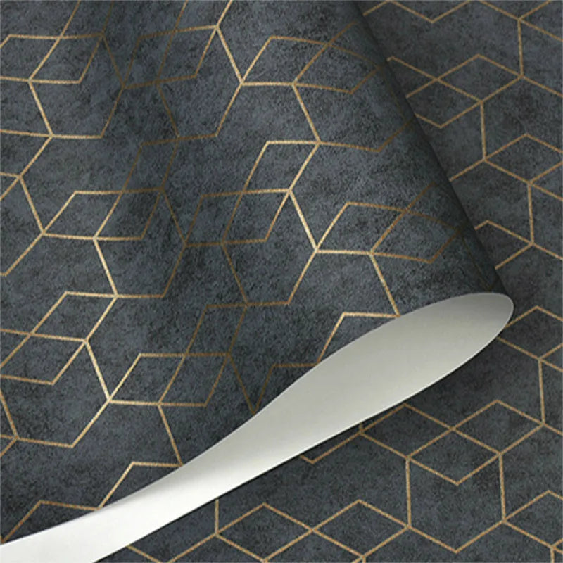 Wallpaper roll with a dark grey textured background and a metallic gold geometric cube pattern.