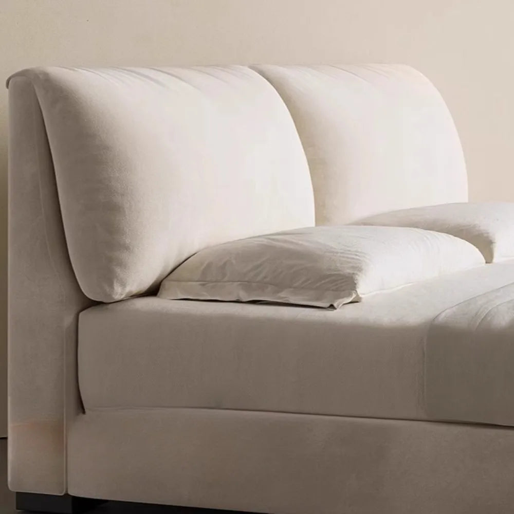 Modern cream velvet storage bed featuring a plush, high-cushioned headboard for a luxurious, contemporary look.