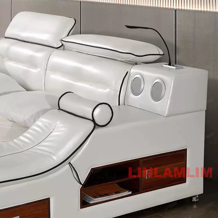 Modern white leather platform bed featuring integrated bedside storage, speakers, and a reading light.