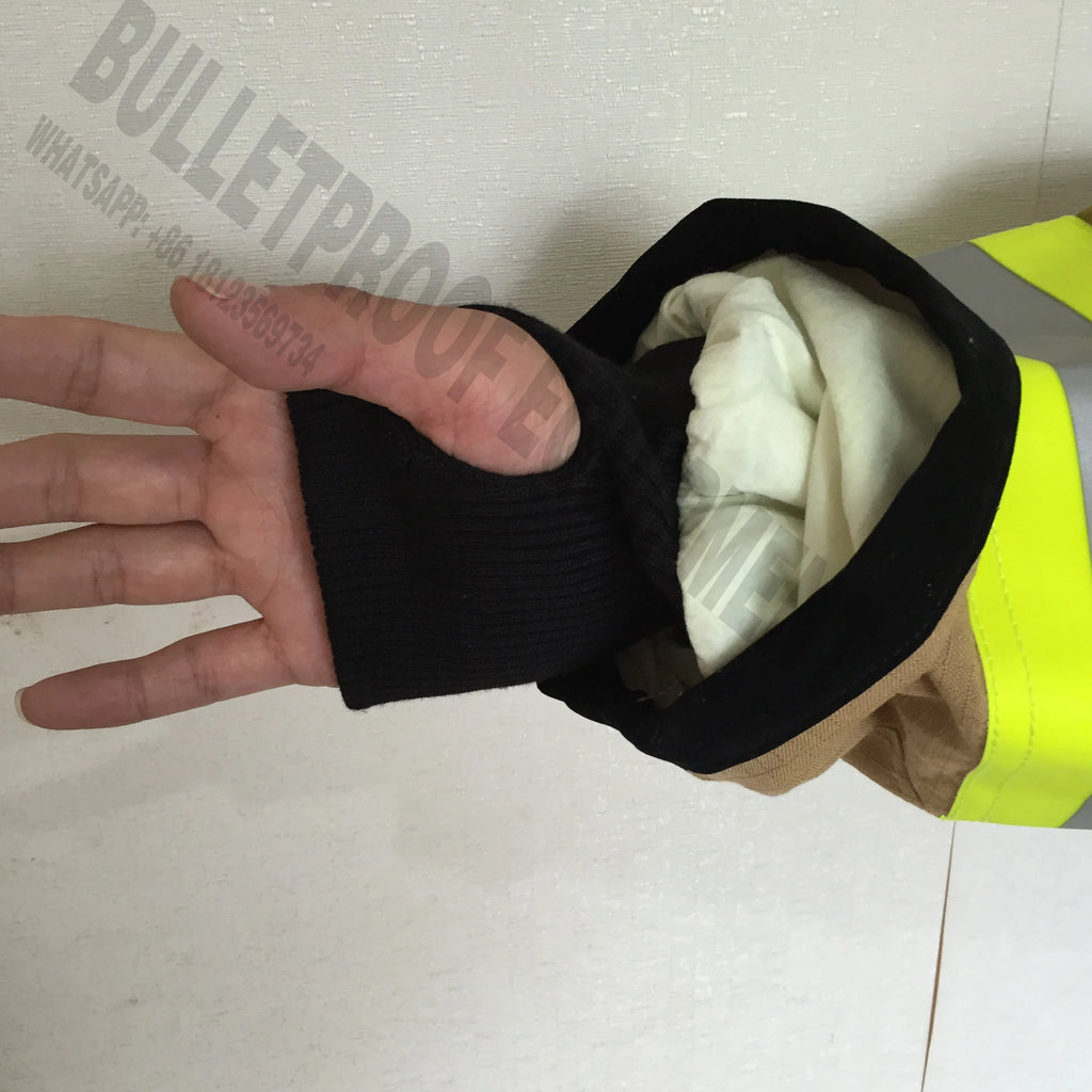 Tan canvas jacket sleeve with high-visibility yellow trim, black ribbed cuff, and thumb hole.