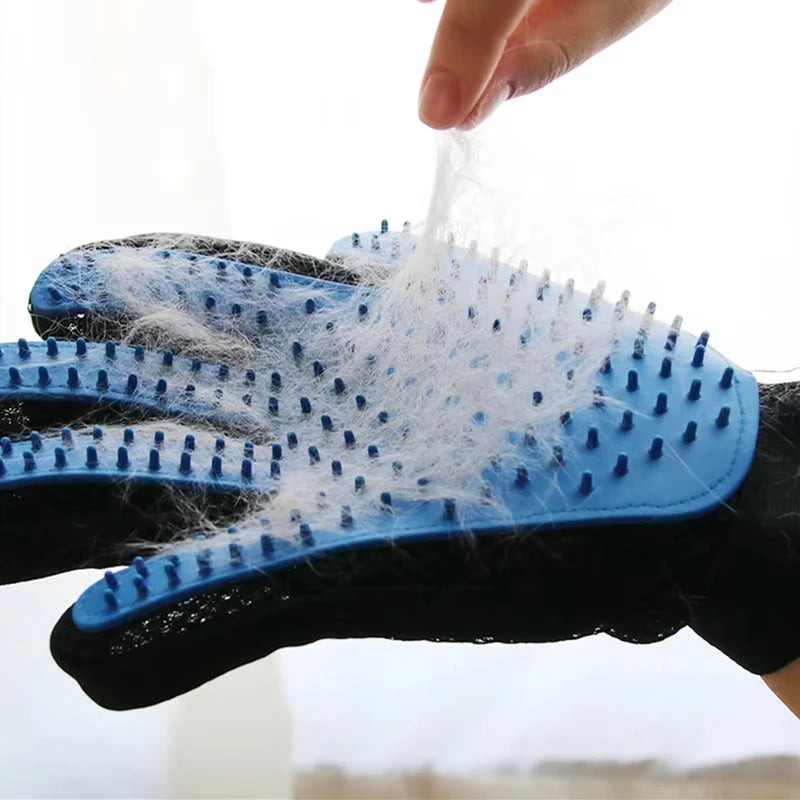 Blue pet grooming glove with rubber grooming spikes, covered in a layer of removed white pet hair.