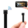 Small black wireless camera module with a ribbon cable, shown being held and displayed on a smartphone screen.