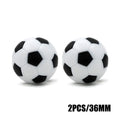 Two 36mm black and white football-style table soccer balls isolated on white.
