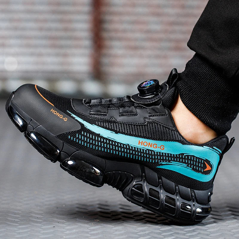 Black steel toe work trainer with blue accents, chunky sole, and a dial-lace system, worn on a metal floor.
