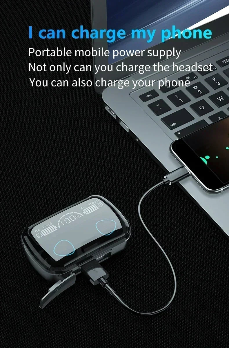 Black charging case with digital display, connected to a smartphone by cable next to a laptop.