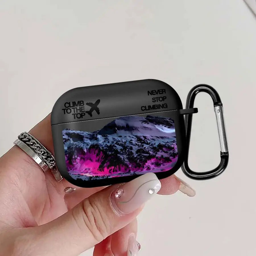 Black matte AirPods Pro case featuring a snowy mountain graphic and 'Never Stop Climbing' text with a black carabiner.