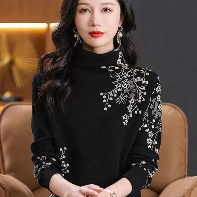 Black turtleneck jumper with white floral embroidery detailing on the shoulder and sleeve.