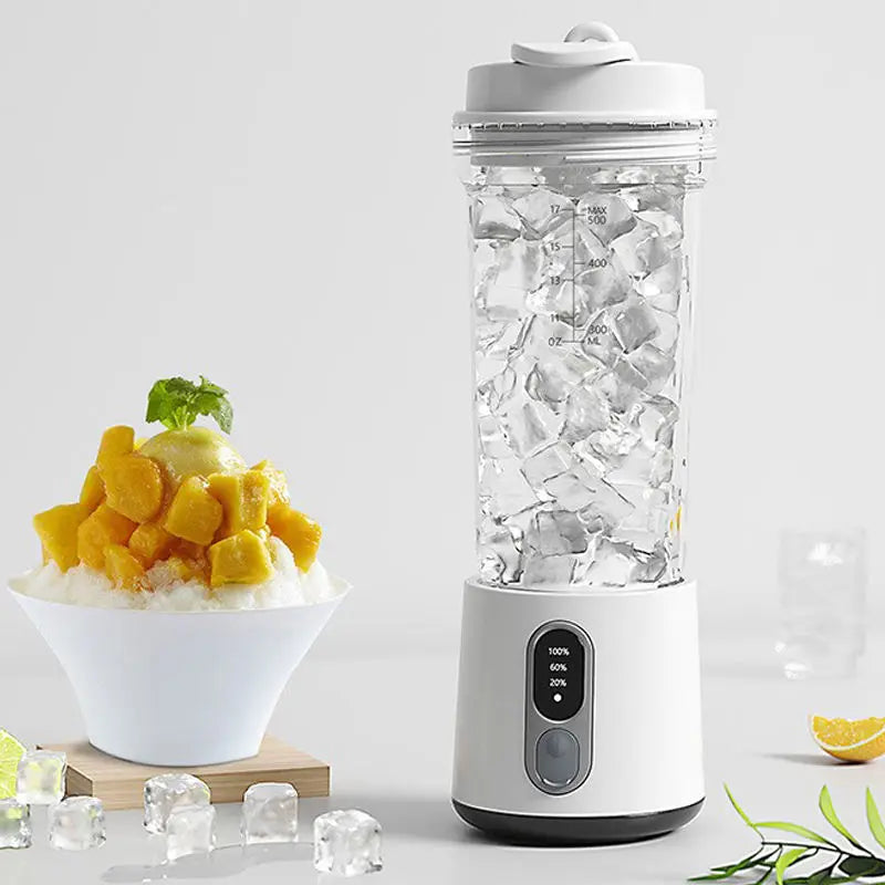 Portable white blender with a clear, measurement-marked container filled with ice, next to a bowl of mango dessert.