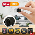 A hand holds a tiny, black wireless security camera with 1080p HD, night vision, and app-controlled motion detection.