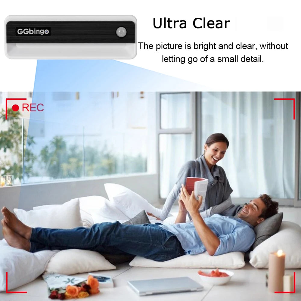 White and black plastic motion sensor security camera filming a couple relaxing on the floor.