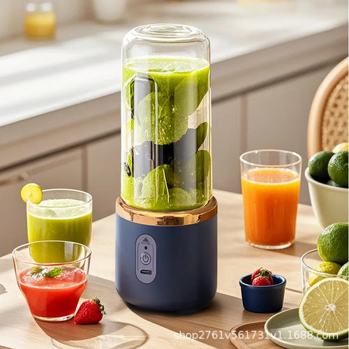 Portable navy blue blender with a clear glass cup, gold rim, and power button, filled with a green smoothie.
