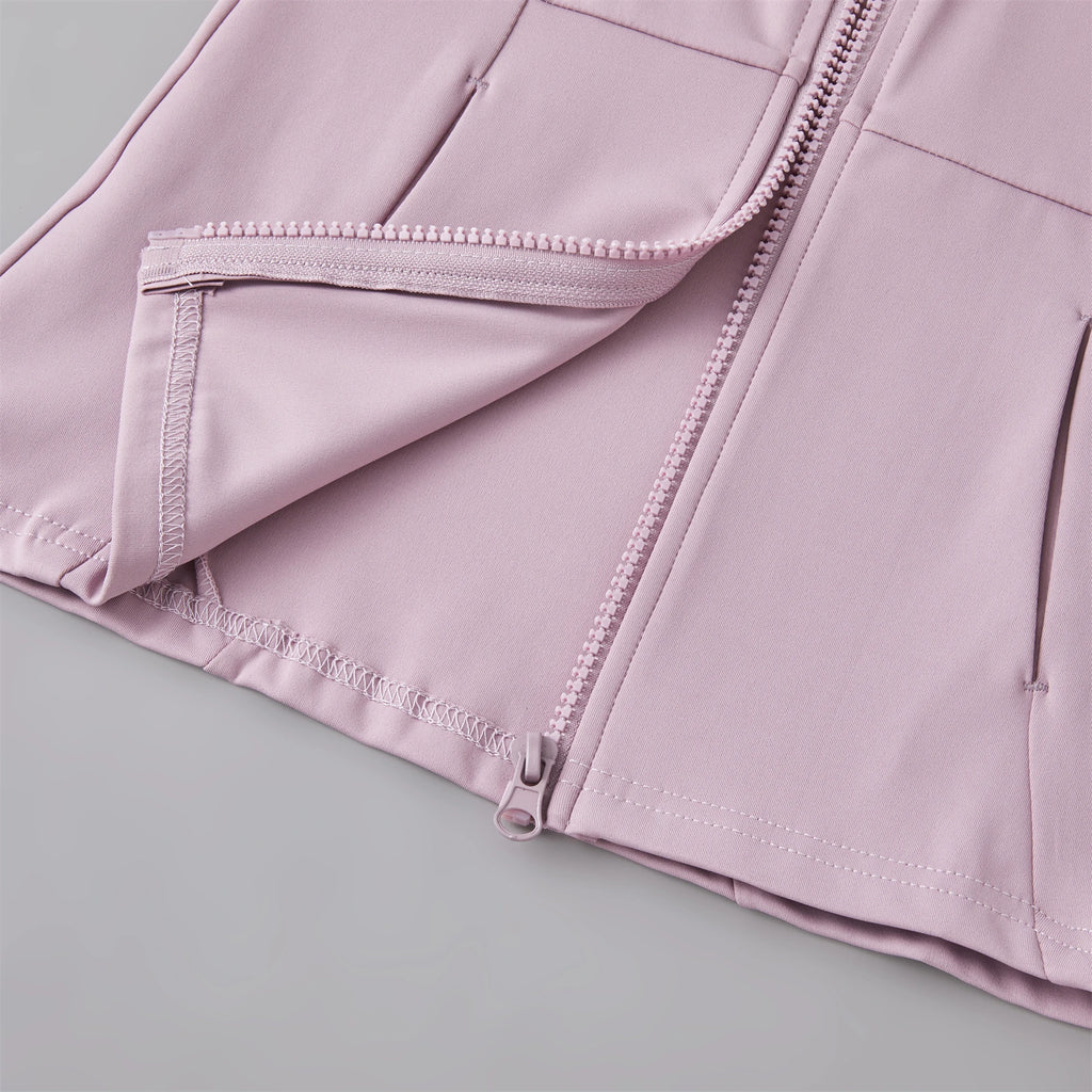 Close-up of a dusty pink lightweight zipped jacket featuring clean seams and secure zip pockets.
