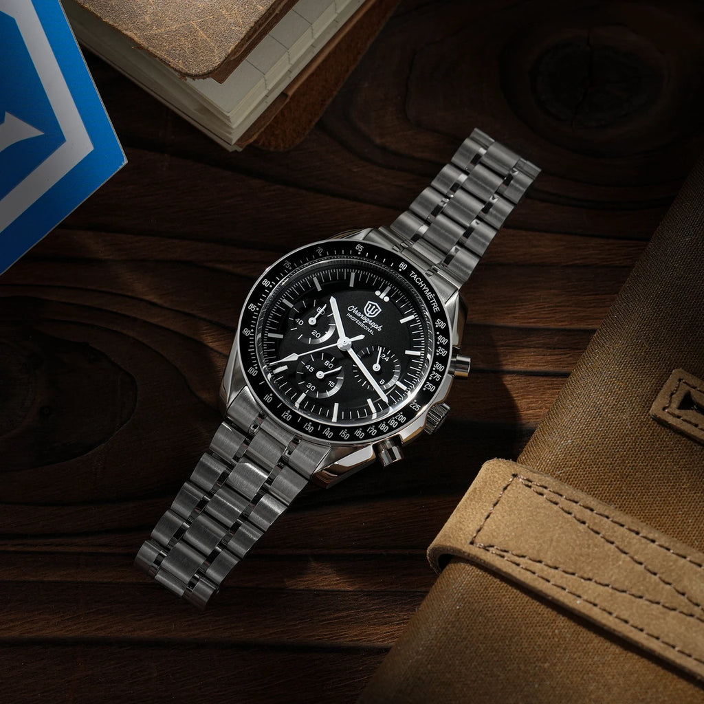 Watchdives WD1860 stainless steel chronograph watch with black dial and metal bracelet on a wooden surface.