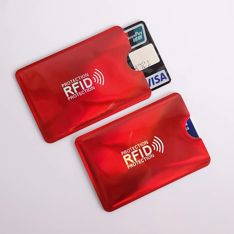 Two metallic red RFID-blocking card sleeves holding credit cards.