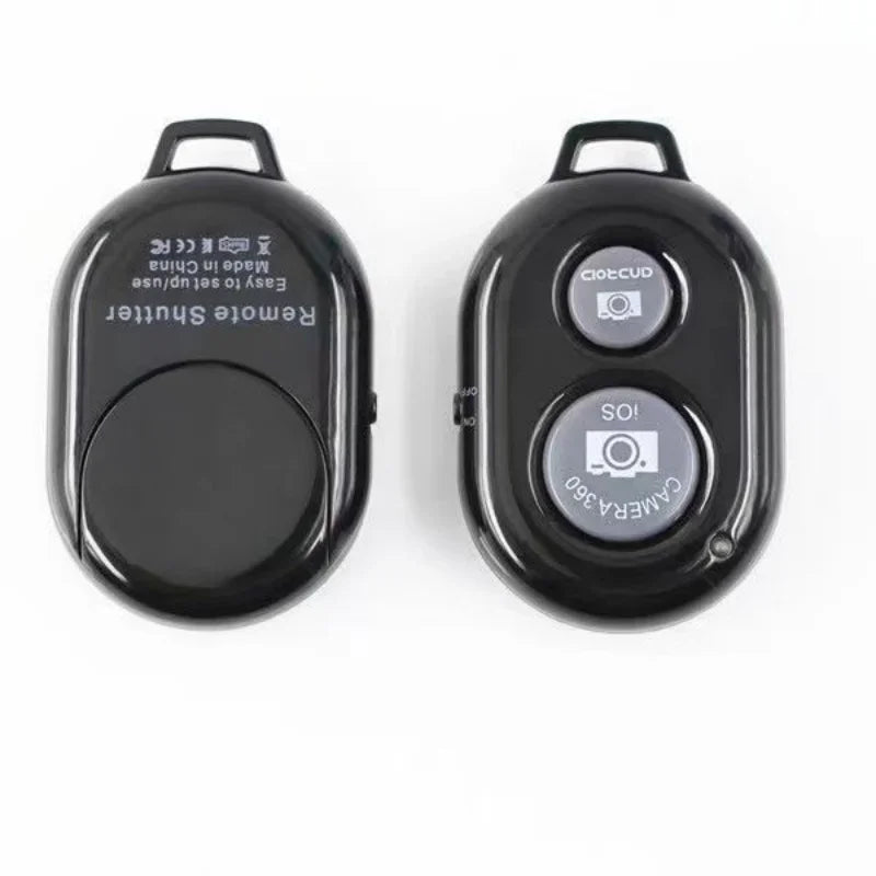 Two black plastic Bluetooth remote shutter buttons for iOS and Android cameras with keychains.