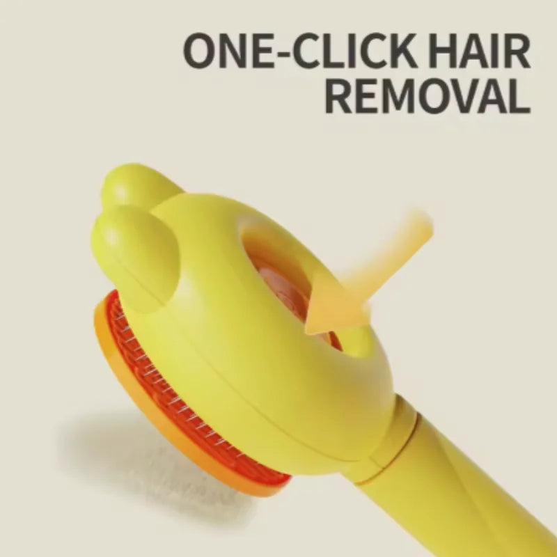 Yellow pet grooming brush with bear-ear design and one-click hair removal button, isolated on a light background.