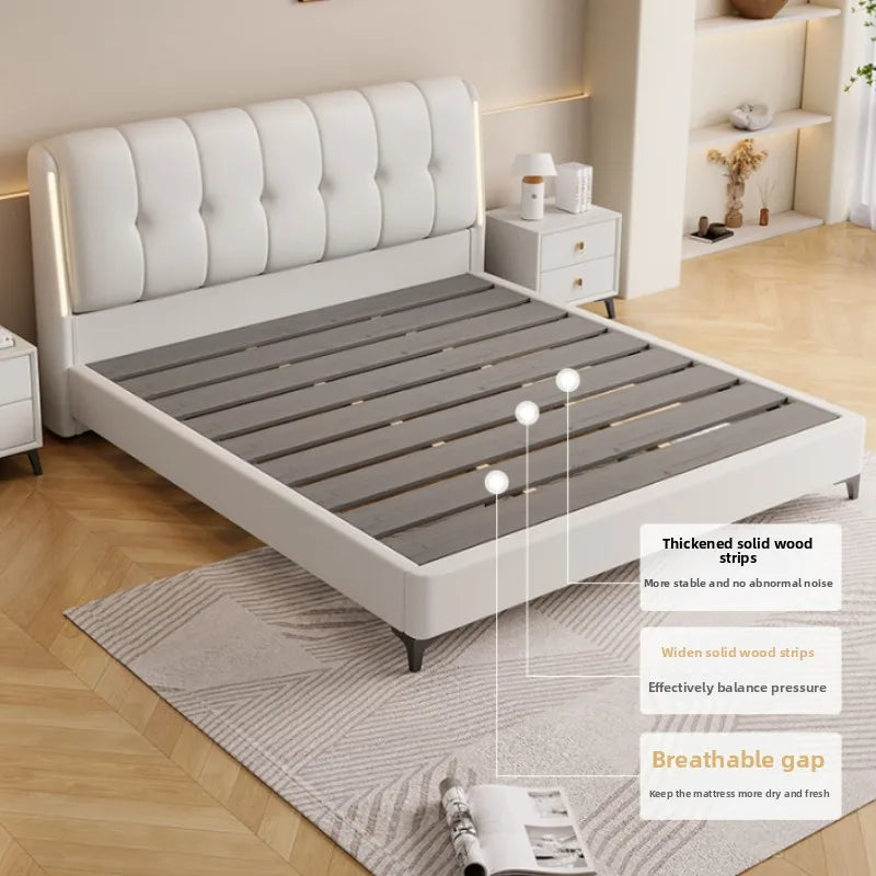 Modern cream white bed frame with a tufted headboard and sturdy grey wooden slats, set in a minimalist bedroom.