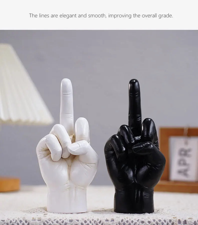 Two hand sculptures in black and white, featuring a smooth, modern design with an upright middle finger gesture.