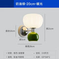 Cream-style wall lamp with a green base, chrome arm, and a globe-shaped white diffuser. Dimensions shown.