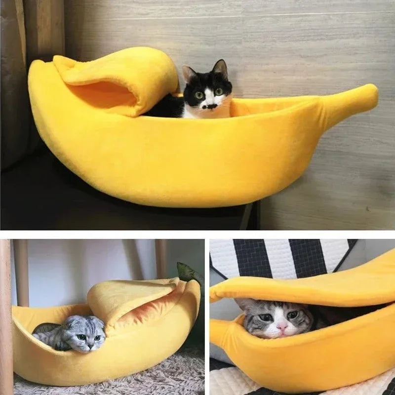Yellow plush banana-shaped pet bed with a peel-back hood, holding cats.