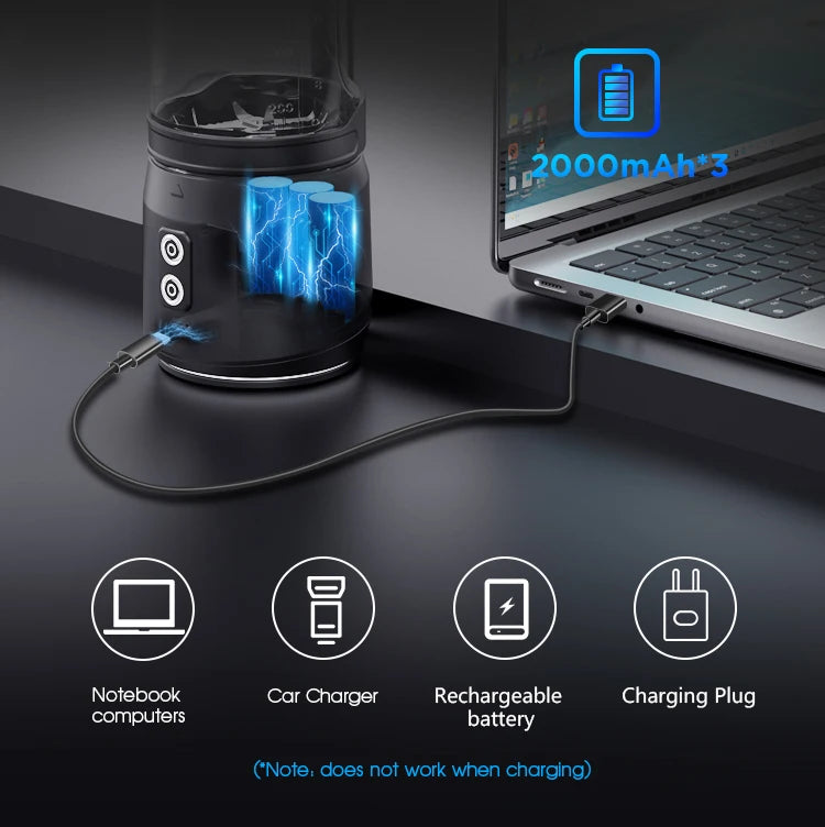 A black portable blender being charged via USB cable from a laptop, showing internal battery and charging icons.