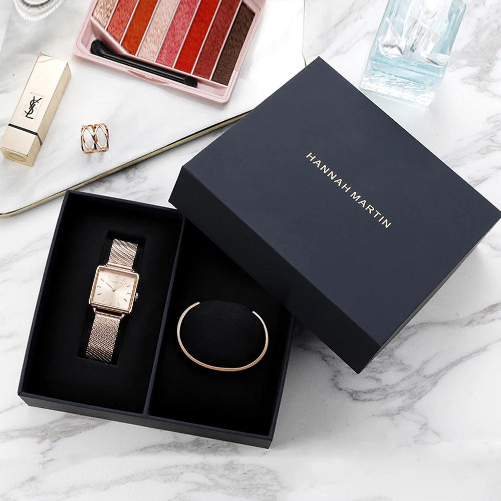Rose gold square quartz watch with stainless steel mesh strap inside a black gift box with a matching bracelet.