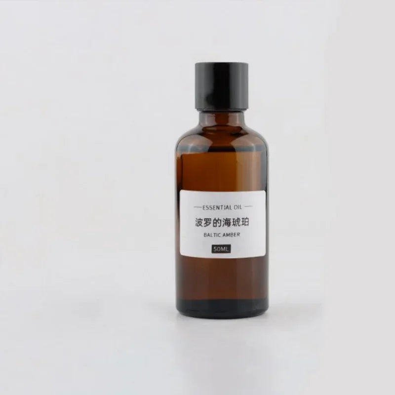 50ml amber glass essential oil bottle with a black screw cap and a minimalist label reading Baltic Amber.