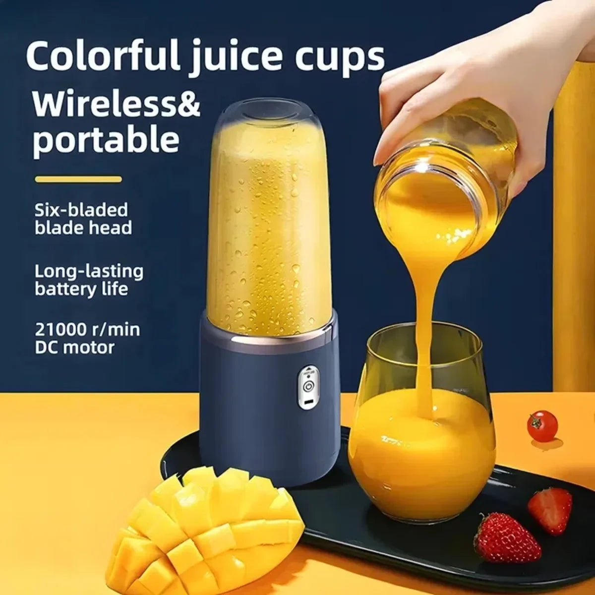Portable wireless blender in dark grey, pouring orange juice into a matching glass, surrounded by fresh fruit.