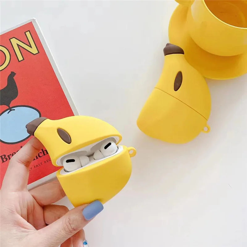 Yellow silicone banana-shaped case for Apple AirPods Pro, with a hand holding the open case.