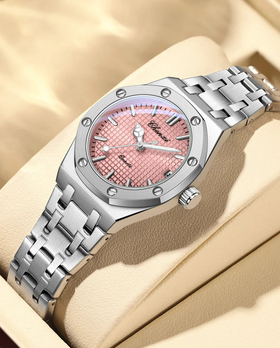 Luxury women's watch with a silver stainless steel bracelet and a textured, blush-pink analogue dial.