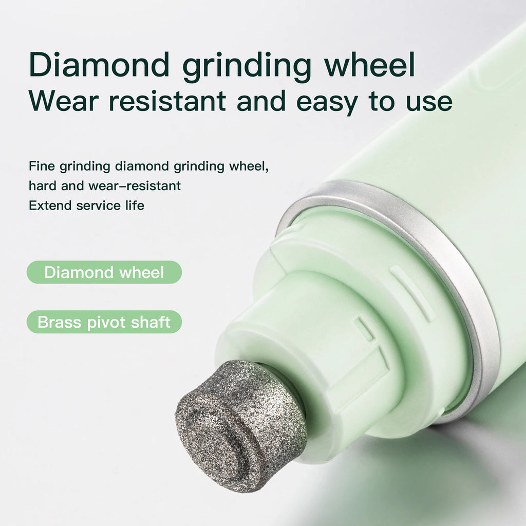 Close-up of a pale green electric pet nail grinder showing the durable diamond grinding wheel and brass pivot shaft.