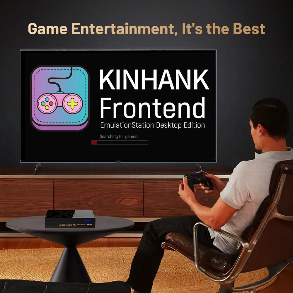 Black Kinhank retro video game console on small table while a man plays game on large TV.