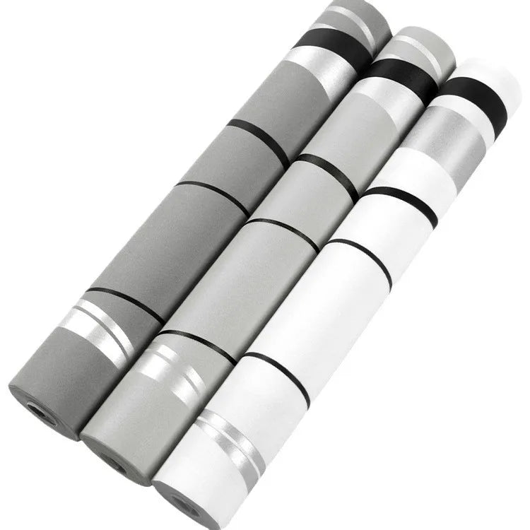 Three rolls of Nordic-style wallpaper featuring a modern geometric design with monochrome stripes and metallic accents.