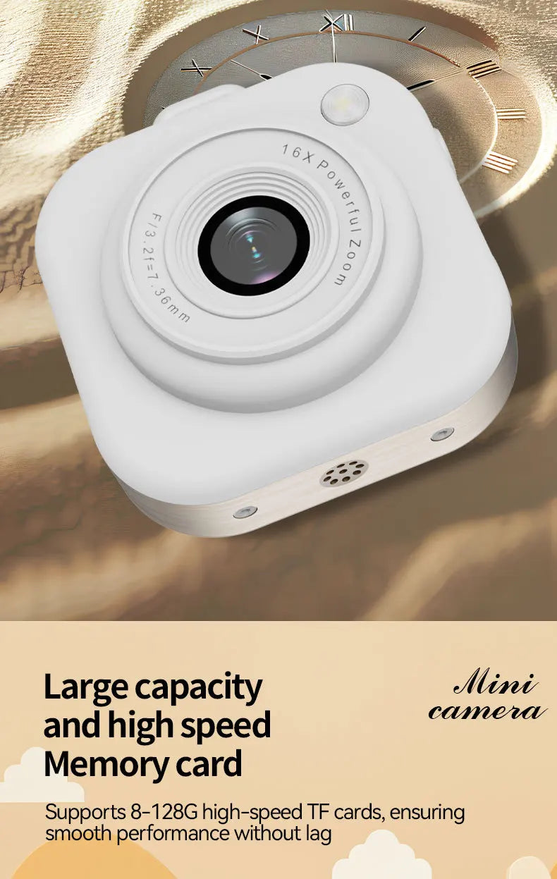 A small, white plastic digital camera with a prominent lens, 16x zoom, and memory card slot.