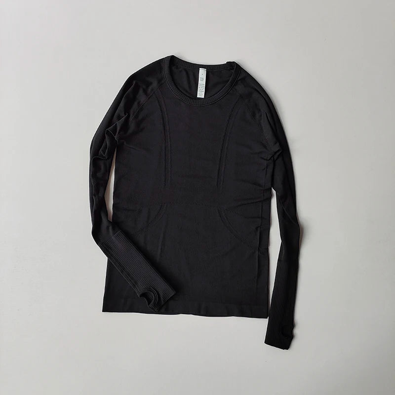 Black seamless long-sleeve workout top with crew neck, ribbed cuffs, and thumbholes.