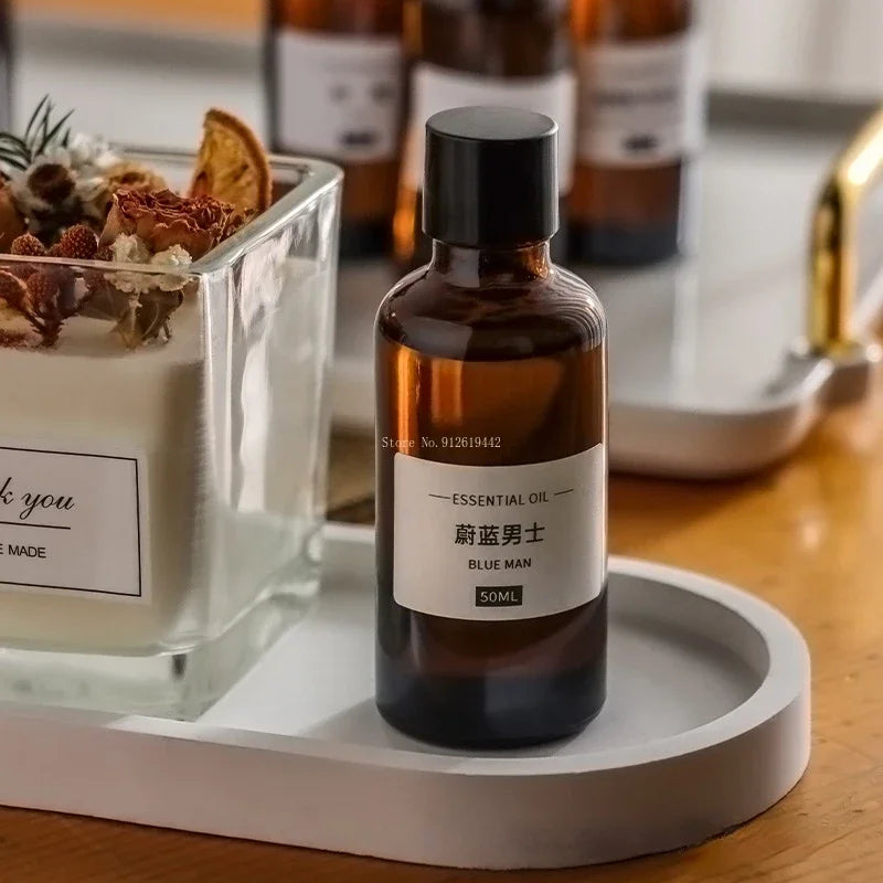 50ml amber glass essential oil bottle with a black cap, featuring a minimalist white label, set on a white tray.